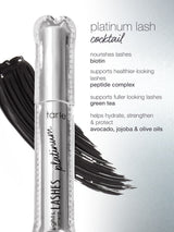 A silver Tarte Cosmetics mascara tube labeled lights, camera, LASHES platinum is placed against a backdrop of black brush strokes. The adjacent text lists ingredients: platinum lash cocktail, biotin, peptide complex, green tea, avocado, jojoba & olive oils, detailing their benefits for lashes.