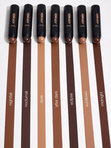 Set of makeup brushes with brown handles and visible brand name on a white background