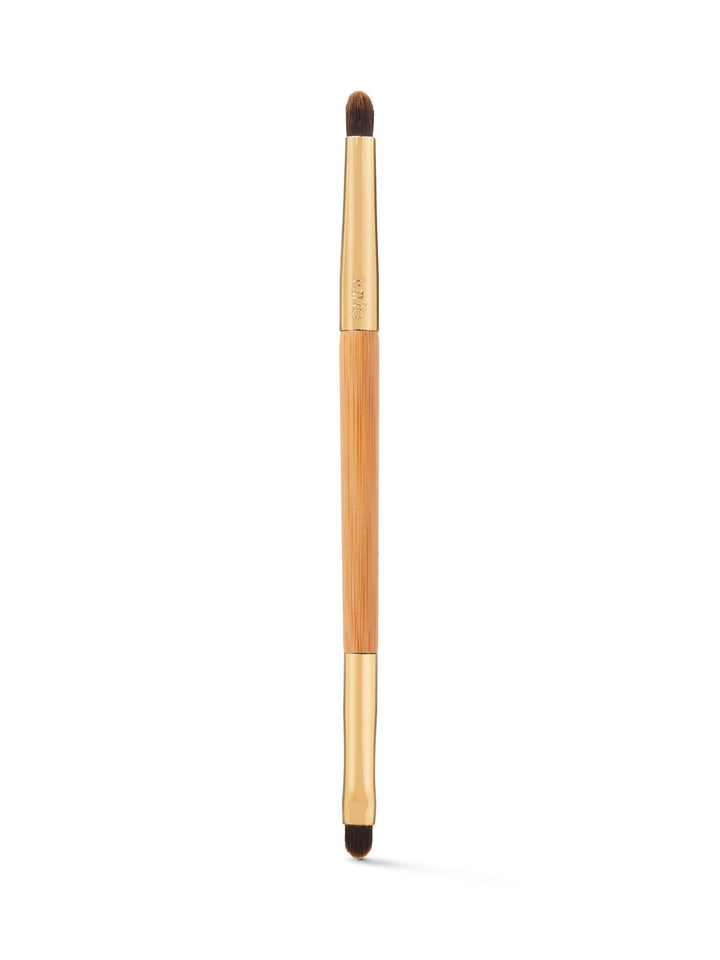 Makeup brush with wooden handle and black bristles on a white background