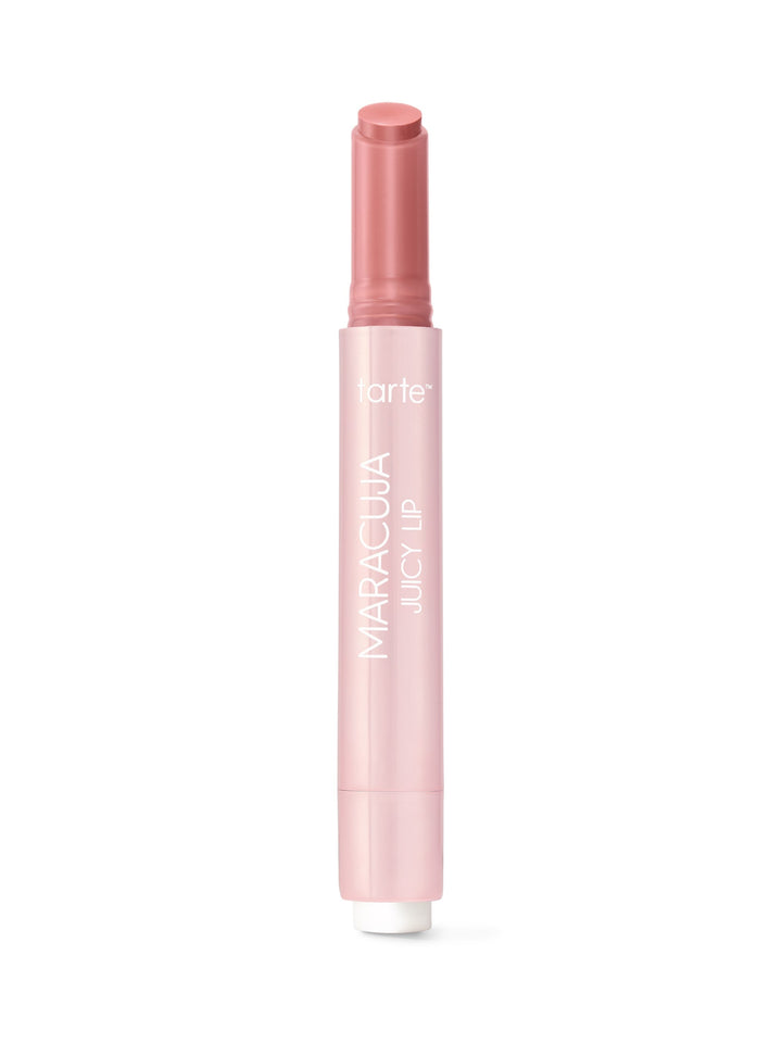 Tarte Maracuja Juicy Lip balm stands upright with cap removed and stick extended against a plain white background. Text on tube: tarte; MARACUJA JUICY LIP.