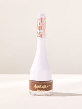 Bottle of Maneater brow product on a light background